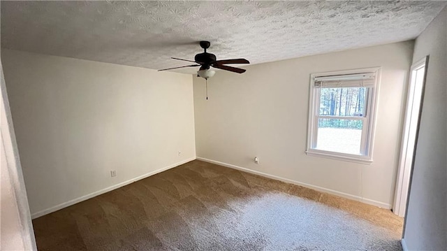 unfurnished room with a textured ceiling, carpet floors, ceiling fan, and baseboards