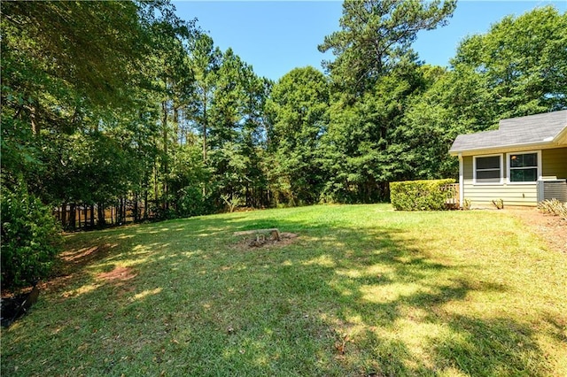 view of yard with fence and central AC unit