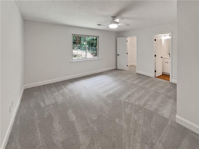 spare room featuring ceiling fan and carpet flooring