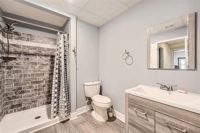46 Grand Georgian Ct NE, Cartersville, GA 30121 - bathroom with toilet, a shower stall, a drop ceiling, vanity, and baseboards
