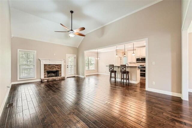 46 Grand Georgian Ct NE, Cartersville, GA 30121 - living area with ceiling fan, high vaulted ceiling, baseboards, dark wood-style floors, and ornamental molding