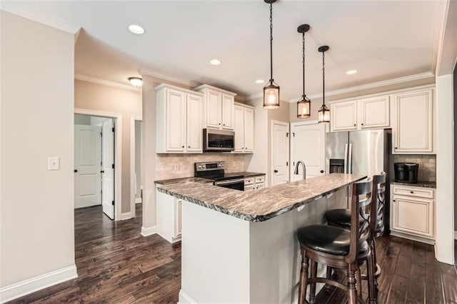 46 Grand Georgian Ct NE, Cartersville, GA 30121 - kitchen with appliances with stainless steel finishes, tasteful backsplash, a kitchen bar, dark wood-type flooring, and ornamental molding