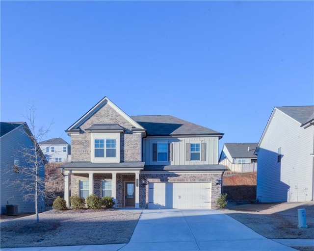 view of front of property featuring a garage and central AC