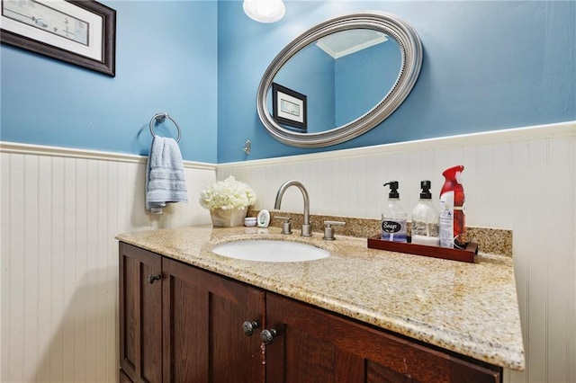 bathroom with vanity and wainscoting