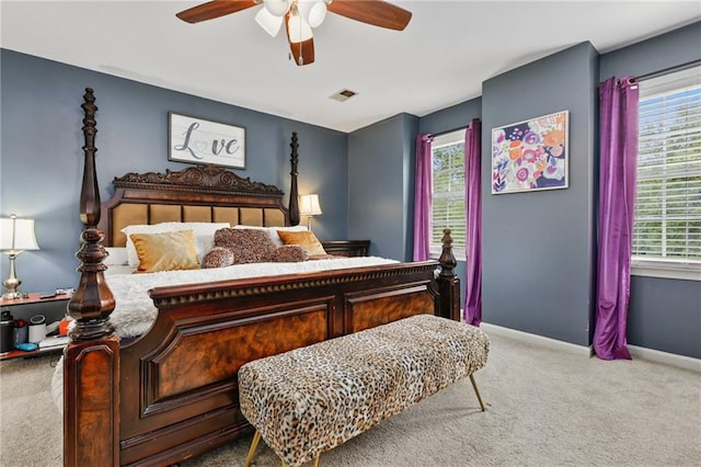 bedroom featuring visible vents, carpet, baseboards, and multiple windows