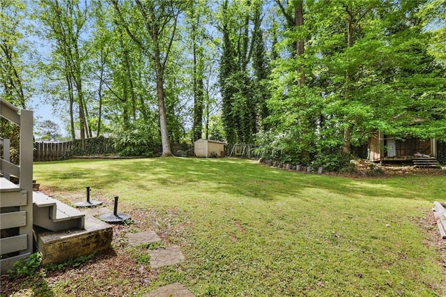 view of yard with a fenced backyard, an outdoor structure, and a shed