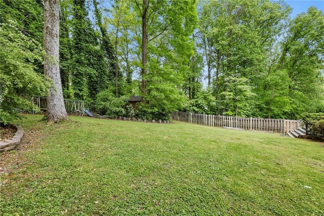 view of yard with a playground and fence
