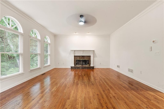 915 Summer Wind Pl, Roswell, GA 30075 - unfurnished living room featuring plenty of natural light, ceiling fan, light wood finished floors, crown molding, and a high end fireplace