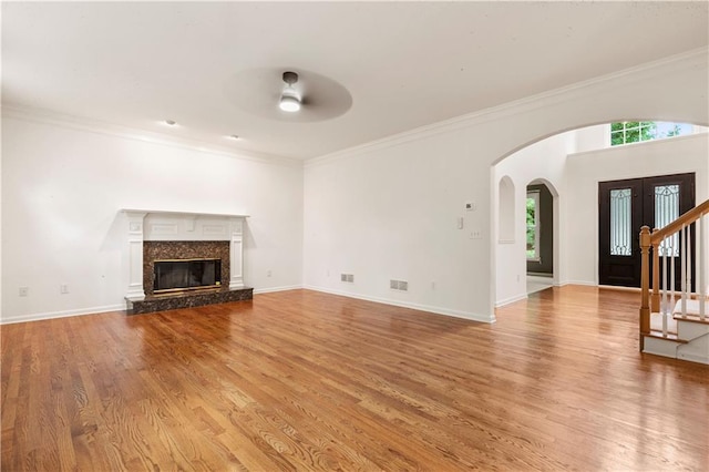 915 Summer Wind Pl, Roswell, GA 30075 - unfurnished living room with a ceiling fan, arched walkways, light wood finished floors, ornamental molding, and baseboards