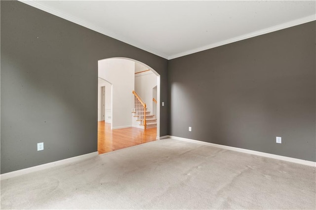 915 Summer Wind Pl, Roswell, GA 30075 - carpeted spare room with arched walkways, crown molding, baseboards, and stairway