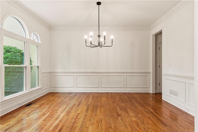 915 Summer Wind Pl, Roswell, GA 30075 - unfurnished dining area featuring a chandelier, wainscoting, ornamental molding, wood finished floors, and a decorative wall
