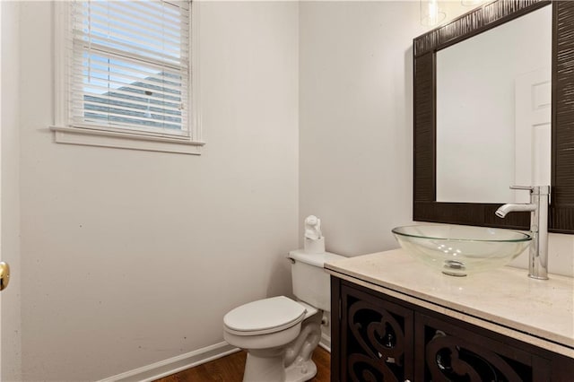 915 Summer Wind Pl, Roswell, GA 30075 - half bathroom featuring toilet, vanity, wood finished floors, and baseboards