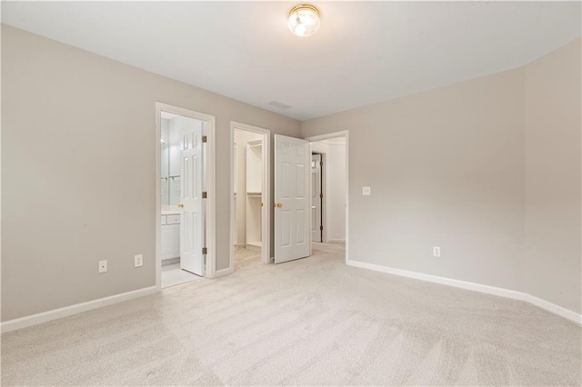 915 Summer Wind Pl, Roswell, GA 30075 - unfurnished bedroom with light colored carpet, a walk in closet, and baseboards