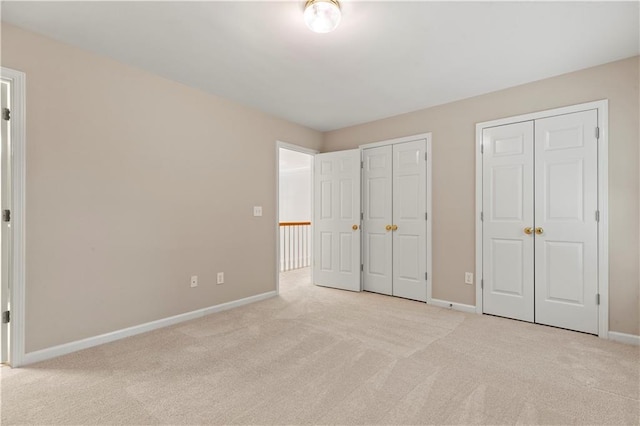 915 Summer Wind Pl, Roswell, GA 30075 - unfurnished bedroom with carpet floors, two closets, and baseboards