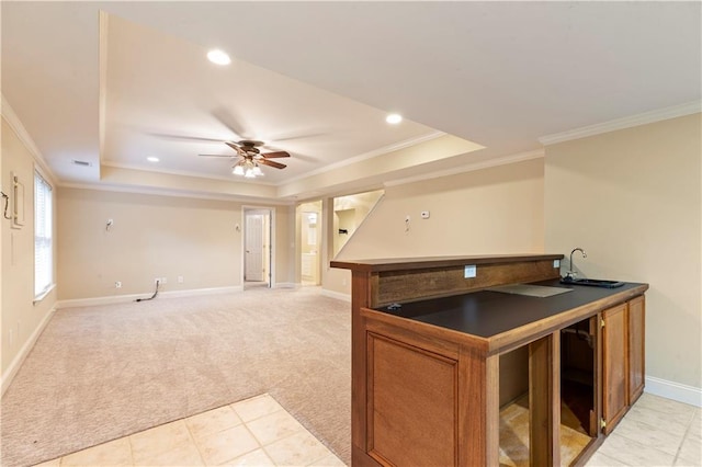 915 Summer Wind Pl, Roswell, GA 30075 - kitchen with a tray ceiling, crown molding, brown cabinetry, baseboards, and a ceiling fan