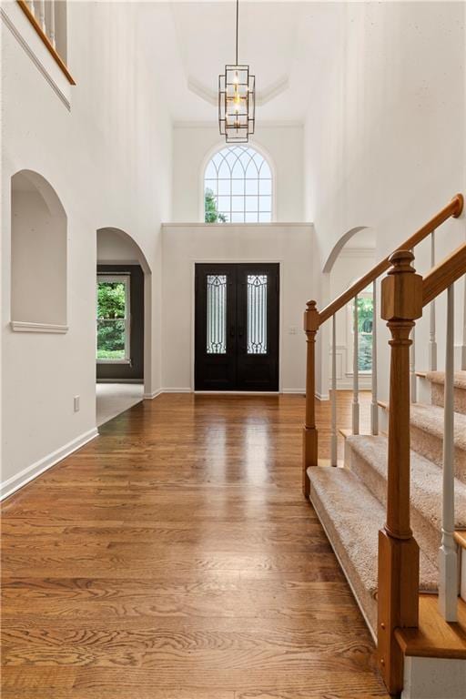 915 Summer Wind Pl, Roswell, GA 30075 - foyer featuring a high ceiling, wood finished floors, french doors, stairway, and arched walkways