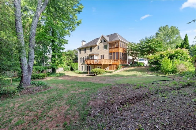 915 Summer Wind Pl, Roswell, GA 30075 - back of property featuring a sunroom, a lawn, a chimney, and a deck