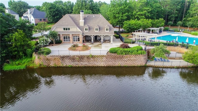 915 Summer Wind Pl, Roswell, GA 30075 - rear view of house with a chimney, a patio area, a water view, a community pool, and a pergola