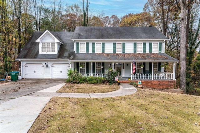 view of front of property with a front yard, a porch, and a garage