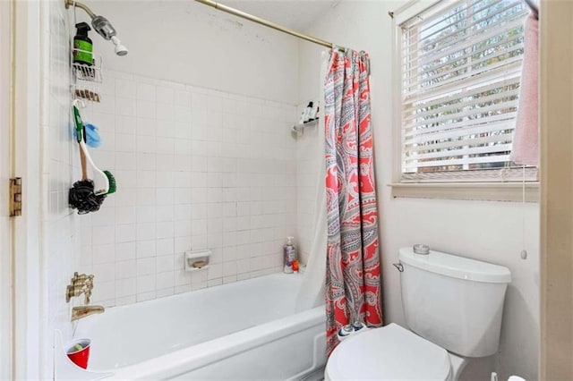 bathroom featuring toilet and shower / tub combo with curtain