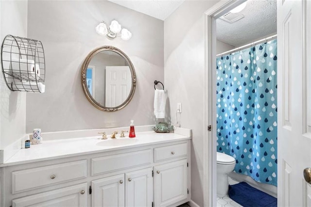 bathroom featuring vanity, tile patterned flooring, toilet, a textured ceiling, and walk in shower