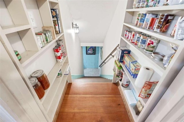 stairs featuring hardwood / wood-style flooring