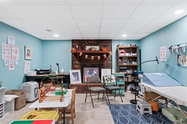 interior space with a paneled ceiling