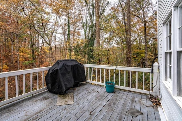 wooden deck featuring a grill