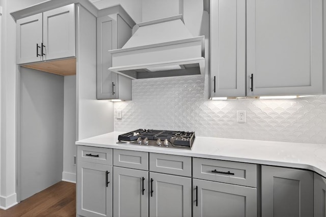 305 Milledge Ave, Monroe, GA 30655 - kitchen featuring custom range hood, gray cabinetry, stainless steel gas cooktop, and light countertops