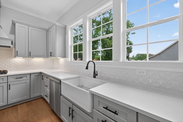 305 Milledge Ave, Monroe, GA 30655 - kitchen featuring dishwasher, decorative backsplash, wood finished floors, gray cabinets, and light countertops