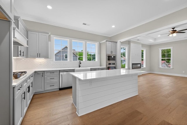 305 Milledge Ave, Monroe, GA 30655 - kitchen with appliances with stainless steel finishes, ornamental molding, decorative backsplash, recessed lighting, and light wood-type flooring