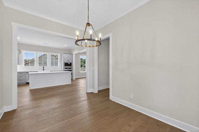 305 Milledge Ave, Monroe, GA 30655 - unfurnished dining area featuring ornamental molding, a chandelier, and dark wood-type flooring
