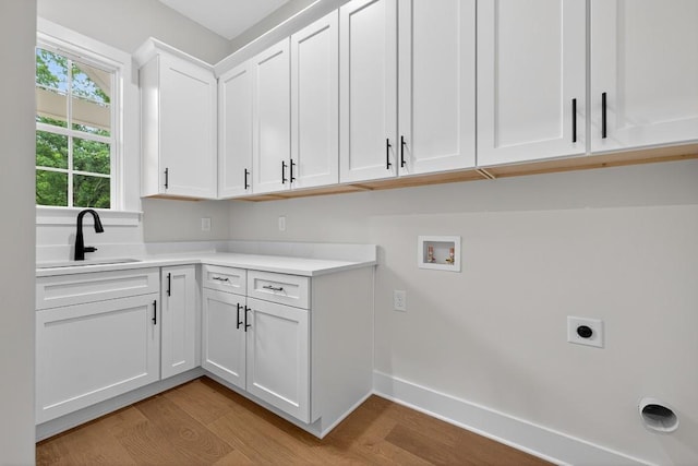 305 Milledge Ave, Monroe, GA 30655 - washroom featuring light wood-style floors, cabinet space, hookup for a washing machine, and electric dryer hookup