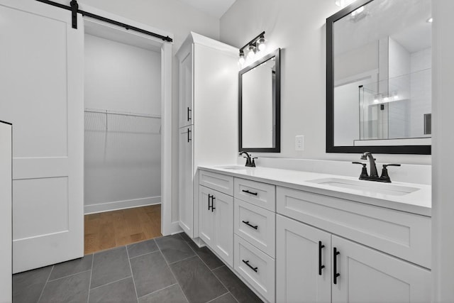 305 Milledge Ave, Monroe, GA 30655 - full bath featuring double vanity, a shower with door, a walk in closet, and tile patterned floors