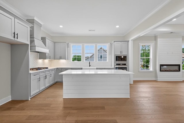 305 Milledge Ave, Monroe, GA 30655 - kitchen featuring a glass covered fireplace, plenty of natural light, stainless steel appliances, light countertops, and recessed lighting