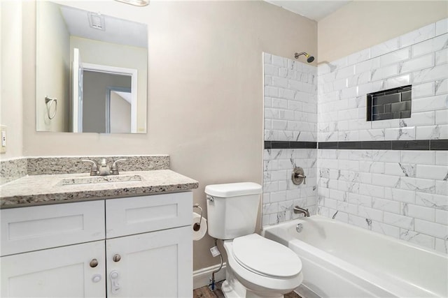 full bathroom with hardwood / wood-style floors, vanity, tiled shower / bath combo, and toilet