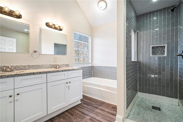 bathroom with plus walk in shower, vanity, hardwood / wood-style flooring, and lofted ceiling