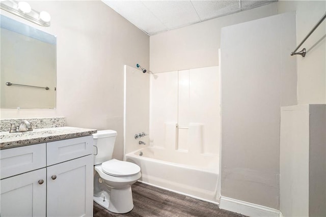 full bathroom featuring toilet, vanity, bathtub / shower combination, and hardwood / wood-style flooring