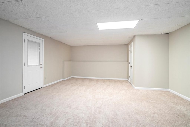 carpeted spare room featuring a paneled ceiling