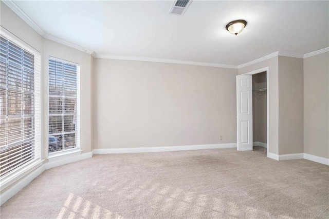 carpeted spare room with crown molding