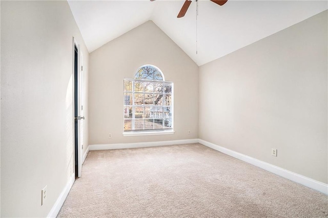 carpeted spare room featuring ceiling fan and lofted ceiling