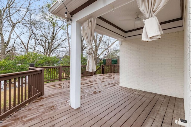 wooden terrace featuring ceiling fan