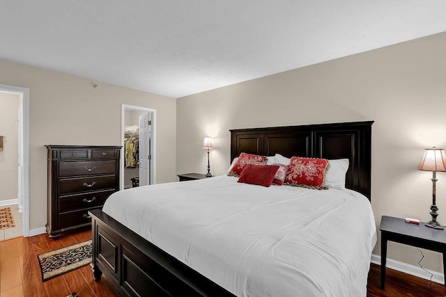 4081 Riverlook Pkwy SE Unit 13, Marietta, GA 30067 - bedroom featuring wood finished floors and a walk in closet