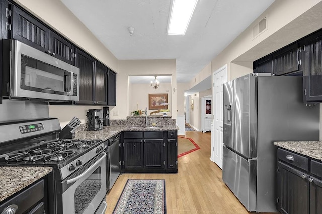 4081 Riverlook Pkwy SE Unit 13, Marietta, GA 30067 - kitchen featuring stainless steel appliances, light wood-type flooring, and dark cabinetry