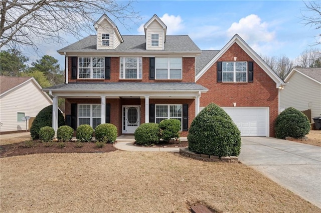 view of front of property featuring a garage, brick siding, a porch, and concrete driveway