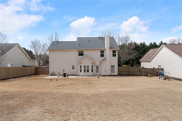 rear view of property with a patio area and a fenced backyard