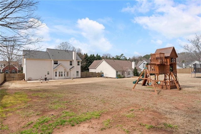 view of yard with a playground, a trampoline, and a fenced backyard