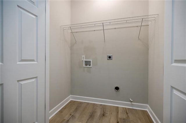 laundry room featuring laundry area, hookup for a washing machine, electric dryer hookup, and baseboards