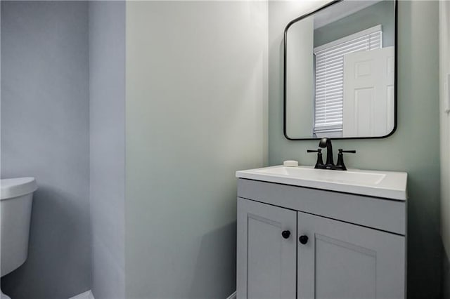 bathroom featuring toilet and vanity