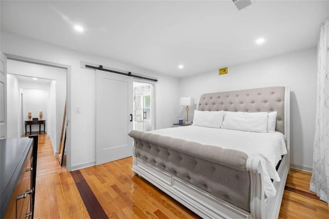 2021 Sherwood Dr SE, Marietta, GA 30062 - bedroom with light wood-style flooring, recessed lighting, a barn door, and access to outside
